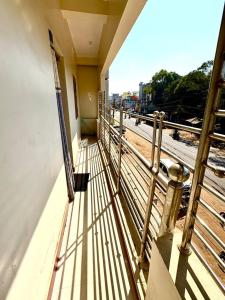 a balcony of a building with a view of a train at Koraput Crown Homestay in Similigurha