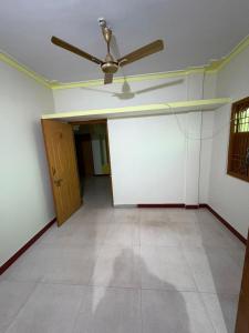 an empty living room with a ceiling fan at Koraput Crown Homestay in Similigurha +1 photo