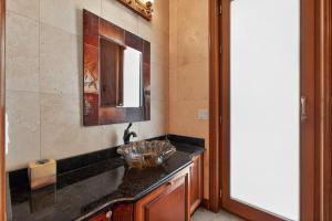a bathroom with a sink and a mirror at AUTHENTIC SANTA FE STYLE VILLA WITH PANORAMIC VIEWS in Gold Canyon +41 photos