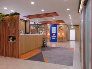 a lobby with a reception desk in a building at The Venezia Suite Hotel in Chuncheon