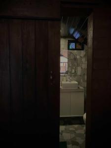 a bathroom with a sink and a mirror at Cabaña en Chachimbiro in Hacienda San Francisco +5 photos