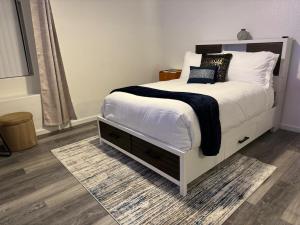 a bedroom with a bed with a black and white blanket at Casa Pueblo in Desert Hot Springs +60 photos