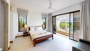 a bedroom with a bed and a large window at Idyllic Samui Beach Villa Resort in Choeng Mon Beach +161 photos