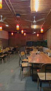 a dining room with wooden tables and chairs at Centre point jawai in Bīsalpur