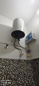 a lamp and a fan in a room at Sita pathik niwas in Jāmb