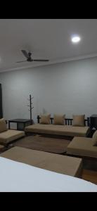 a room with two beds and a cross on the wall at Centre point jawai in Bīsalpur
