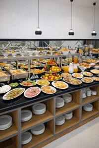 a buffet with many plates of food on display at Vatan Hotel in Dushanbe