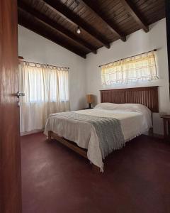 a bedroom with a bed and a window at Cabañas Pukara in Cafayate