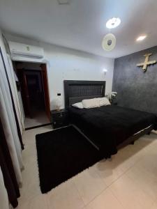 a bedroom with a bed with a cross on the wall at suites vergel terraza in Orizaba