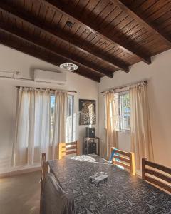 a dining room with a table and some windows at Cabañas Pukara in Cafayate