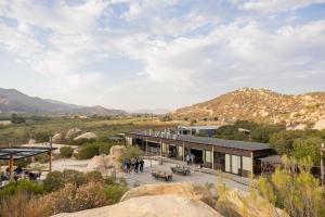a rendering of a building with mountains in the background at OENO WINE LODGE Valle de Guadalupe in Valle de Guadalupe
