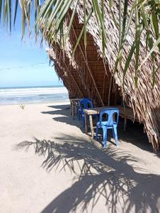 a group of chairs and a table on the beach at El Hermosa Bice Camp in El Nido