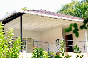 a house with a porch and a balcony at Kghomestay in Pallipuram
