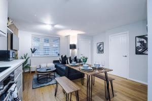 a living room with a couch and a table at 2 BDR House By Eason Stays Short Lets Stockport in Stockport