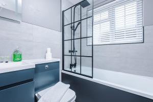 a bathroom with a shower and a toilet and a sink at 2 BDR House By Eason Stays Short Lets Stockport in Stockport +76 photos