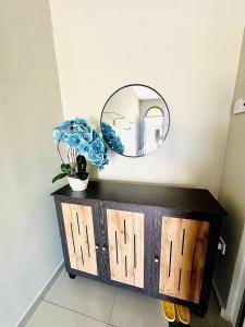 a mirror on top of a wooden dresser in a room at Homestay Babah - Private Chalet in Malacca