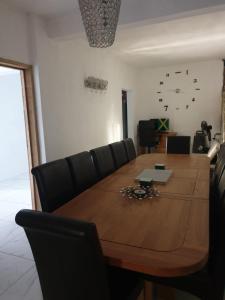 a dining room table with black chairs around it at Cambridge Heights Guest House in Port Maria +9 photos