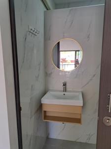 a bathroom with a sink and a mirror at Bancha white house in Ban Bo Han +34 photos