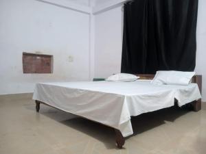 a bed with two pillows on it in a room at Magic of magh snan in Prayagraj