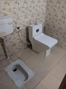 a bathroom with a toilet and a sink at Magic of magh snan in Prayagraj