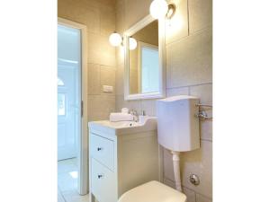 a bathroom with a sink and a toilet and a mirror at Private Hideaway in ut Island in Otočić Svršata Mala