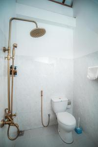 a bathroom with a toilet and a shower at Prime Time Hotel in Unawatuna