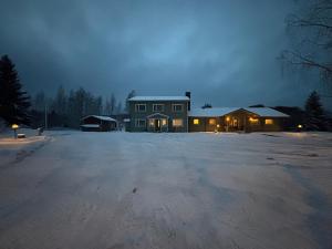 a house in the middle of a snow covered parking lot at Villa Sillankorva in Viitasaari
