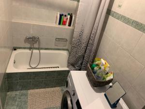 a bathroom with a tub and a shower and a washing machine at Vicky 's Luxury House in Nafpaktos +58 photos