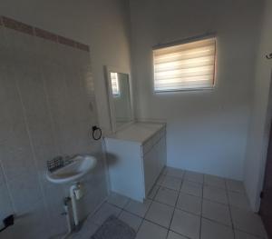 a white bathroom with a sink and a window at Palm Beach 278 in Palm-Eagle Beach +50 photos