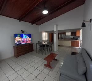 a living room with a couch and a tv and a table at Palm Beach 278 in Palm-Eagle Beach
