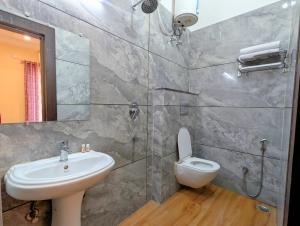 a bathroom with a sink and a toilet at Ganga Yamuna View in Prayagraj +37 photos