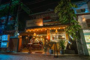 a restaurant with lights in front of it at night at Prime Time Hotel in Unawatuna