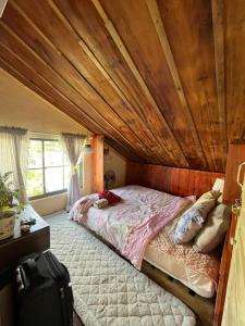 een bed in een kamer met een houten plafond bij Hạ Hoàng Hôn House & Coffee in Da Lat