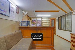 a waiting room with a bench in a restaurant at Collection O Dandiya Bazar Formerly Vrundavan Residency in Vadodara