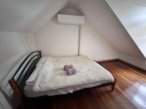 a small bedroom with a bed with a teddy bear on it at 2 Bedroom Pyrmont Terrace House in Sydney