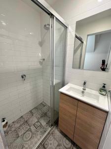 a bathroom with a sink and a shower at 2 Bedroom Pyrmont Terrace House in Sydney