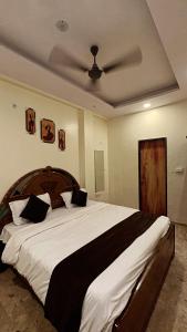 a bedroom with a large bed with a wooden headboard at Hotel Castle in Indore