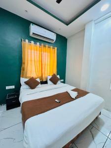 a bedroom with a large bed with a window at Hotel Castle in Indore
