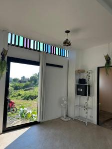 a room with a sliding glass door with a window at Fluffy Cat Paradise in Ko Bu Bu