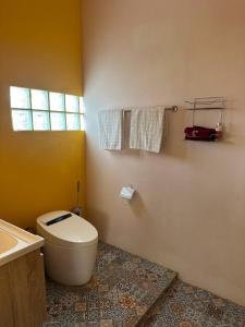 a bathroom with a toilet and a sink at Fluffy Cat Paradise in Ko Bu Bu +10 photos