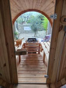 una porta aperta su un portico in legno con una griglia di Holiday Home Inga with free private parking a Fiume (Rijeka)