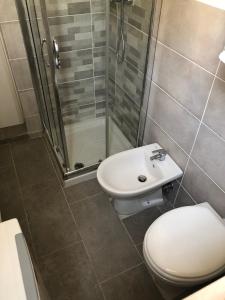 a bathroom with a shower and a toilet and a sink at SantegidioHomeCesena in Cesena