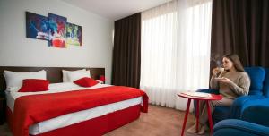 En eller flere senge i et værelse på Da Vinci Boutique Hotel