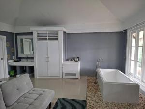 a bathroom with a couch and a bath tub at Purin Resort & Restaurant- SHA Plus in Had Yao Beach +58 photos