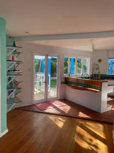 a room with a kitchen with a counter and a table at Breaker Bay Paradise in Wellington