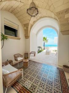 an archway in a living room with a view of the beach at Palma Residence Salento in San Foca +107 photos