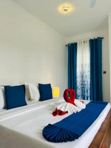 a bed with a red heart on top of it at New Aqua Glory in Negombo