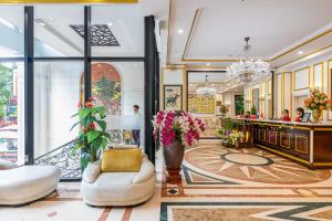 a lobby of a store with white furniture and flowers at Chill Hotel Ha Bong in Danang