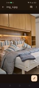 a large bed in a room with wooden cabinets at 50 passi dal mare in Sestri Levante