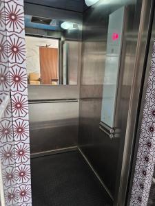 a bathroom with a glass door and a mirror at Hotel Space Comfort Inn in Karmād +10 photos